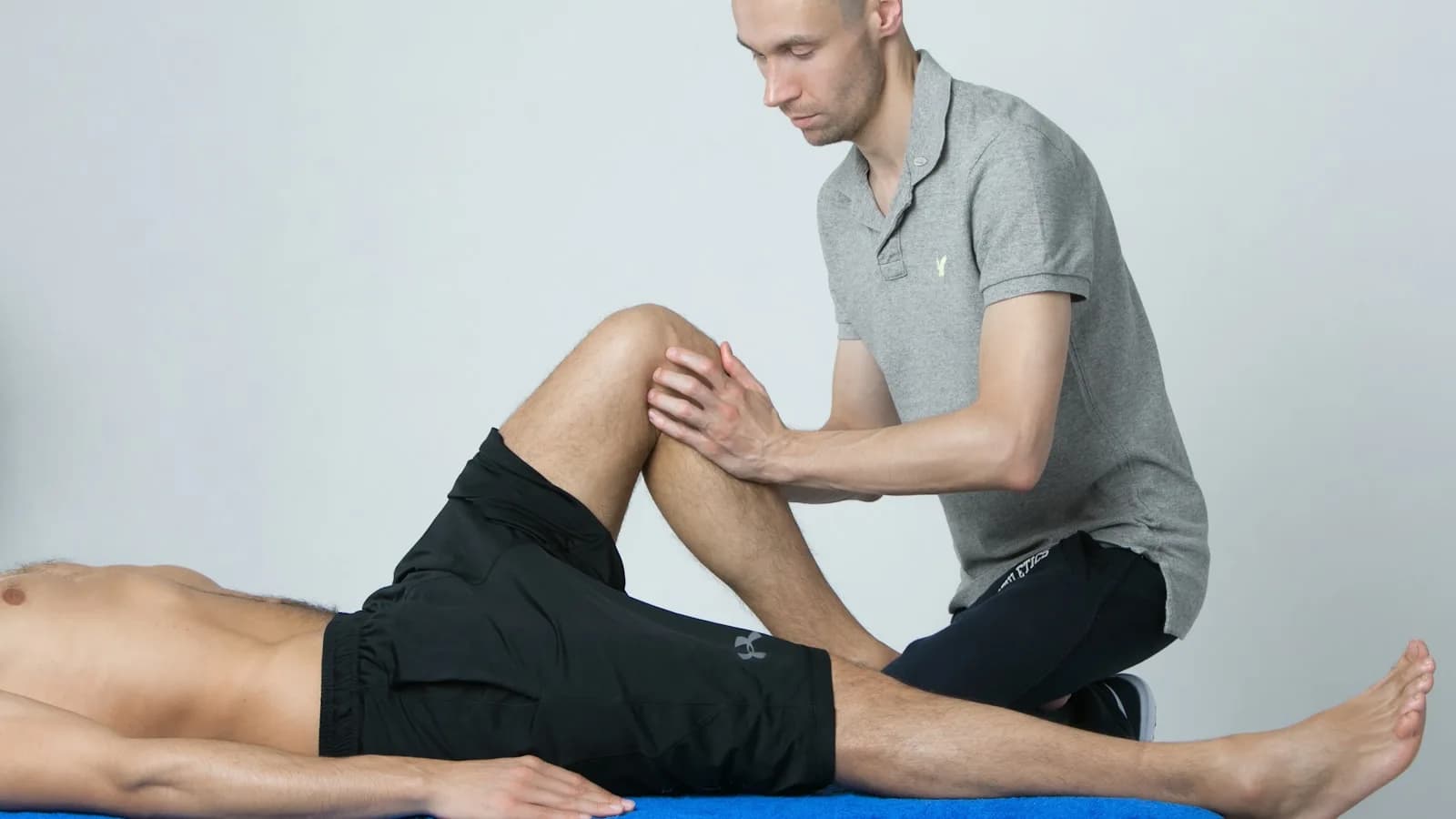 Non-surgical knee osteoarthritis physiotherapy in Bangalore — Pro Physiotherapy JP Nagar clinical photograph of a physiotherapist performing knee assessment and cartilage preservation exercise therapy on a middle-aged patient with knee OA to delay or avoid total knee replacement, evidence-based GLA:D neuromuscular exercise programme, quadriceps and glute strengthening, weight-management coaching for JP Nagar, Jayanagar, BTM Layout, Basavanagudi and Bannerghatta patients, sessions from ₹600, insurance-compliant GST bill provided