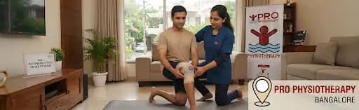 ACL reconstruction rehab at home in Bangalore — Pro Physiotherapy JP Nagar female MPT physiotherapist guiding a young male patient through single-leg squat, closed-chain quadriceps activation, at-home ACL post-surgical protocol