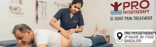SI Joint Pain Treatment in Bangalore | 6-Step Sacroiliac Recovery | Pro Physiotherapy JP Nagar SI joint pain treatment at Pro Physiotherapy JP Nagar 8th Phase Bangalore — female MPT physiotherapist performing sacroiliac joint mobilisation and muscle-energy technique on a prone male patient with pelvic girdle pain