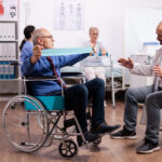disabled-senior-man-doing-his-exercises-hospital-with-physiotherapy-doctor